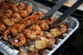 Barbecue shrimps on grill with grippers Royalty Free Stock Photo