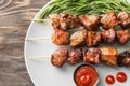 Barbecue skewers with juicy meat and sauce on plate Royalty Free Stock Photo