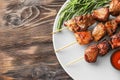 Barbecue skewers with juicy meat and sauce on plate Royalty Free Stock Photo