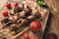 Barbecue skewers with juicy meat on wooden board Royalty Free Stock Photo