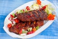 Barbecue spare ribs from a grill with vegetables Royalty Free Stock Photo