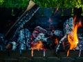 barbecue woods, flame fire, ash coals burning in metal grill preparing for BBQ Royalty Free Stock Photo