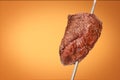 Barbecued Picanha barbecue with orange background. Also called churrasco