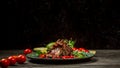 Barbecued Pork Back. Pork ribs on a modern plate with berry sauce and cherry tomatoes, lime and chilli. pea sprouts, sunflower and Royalty Free Stock Photo