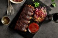 Barbecued pork ribs served with coleslaw and sauce Royalty Free Stock Photo