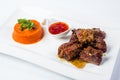 Barbecued pork ribs served with tomato sauce and Royalty Free Stock Photo