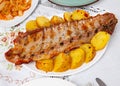 Barbecued pork spare ribs with baked potatoes on plate Royalty Free Stock Photo