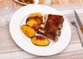 Barbecued pork spare ribs with baked potatoes on plate Royalty Free Stock Photo