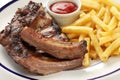 Barbecued pork spare ribs and french fries Royalty Free Stock Photo