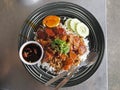 Thai food - BBQ red pork and deep fried crispy pork with sauce on rice. Royalty Free Stock Photo