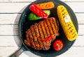 Barbecued rib eye beef steak with corn on the cob Royalty Free Stock Photo