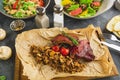 Barbecued ribs, buckwheat with mushroom and tomatoes on wooden board and salad Royalty Free Stock Photo