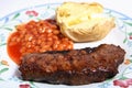 Barbecued sirloin steak baked beans and potato Royalty Free Stock Photo