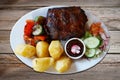 Barbecued spareribs with tomatoes and salad Royalty Free Stock Photo