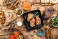 Barbecued steak, sausages, beer and grilled vegetables on wooden