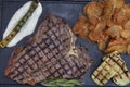 Barbecued t-bone steak seasoned with fresh herbs and marinade served with a cutting board in a steakhouse. Delicious restaurant Royalty Free Stock Photo