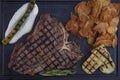 Barbecued t-bone steak seasoned with fresh herbs and marinade served with a cutting board in a steakhouse. Delicious restaurant