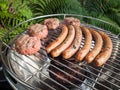 Barbecueing sausages and beefburgers Royalty Free Stock Photo