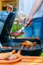 Barbecuing meat on grill.