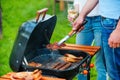 Barbecuing meat to perfection. Royalty Free Stock Photo