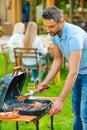 Barbecuing meat to perfection. Royalty Free Stock Photo