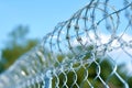 Barbed and razor wire fence. Fencing the state border against immigration