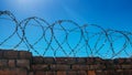 Barbed steel wire on a stone fence Royalty Free Stock Photo