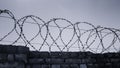 Barbed steel wire on a stone fence Royalty Free Stock Photo