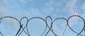 Barbed wire against a blue sky Royalty Free Stock Photo