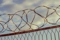 Barbed wire against the sky with clouds. The prohibition of air travel Royalty Free Stock Photo