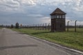 Barbed wire around a concentration camp. Shed guard in the background. Royalty Free Stock Photo