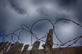 Barbed wire on the background of clouds over Royalty Free Stock Photo