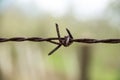 Old bared wire, security wire, rusty wire, Barbed wire. Barbed wire on the fence with the blue sky to worry about. Royalty Free Stock Photo