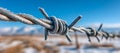 Barbed wire on a blue background via image technology Royalty Free Stock Photo