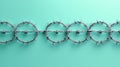 Barbed wire circles arranged in line on turquoise background, creating striking visual contrast