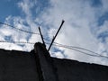 barbed wire close-up against a blue sky, the concept of incarceration, serving a sentence, restriction of freedom, isolation, crim