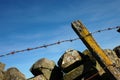 Barbed wire and a dry-stone wall Royalty Free Stock Photo