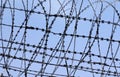 Barbed wire fence against blue sky background Royalty Free Stock Photo