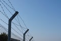 Barbed wire fence against blue sky Royalty Free Stock Photo