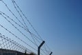 Barbed wire fence against blue sky Royalty Free Stock Photo