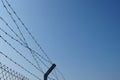 Barbed wire fence against blue sky Royalty Free Stock Photo