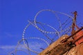 barbed wire on the fence against the sky and the sun Royalty Free Stock Photo