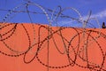 barbed wire on the fence against the sky and the sun Royalty Free Stock Photo