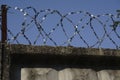 Barbed wire fence attached around prison walls