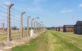 The barbed wire fence and the barracks in concentration camp Auschwitz II - Birkenau.