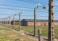 The barbed wire fence and the barracks at concentration camp Auschwitz II - Birkenau, Poland.