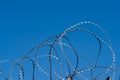 Barbed wire on fence with blue sky Royalty Free Stock Photo