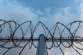 Barbed wire fence with bright blue sky to feel silent and lonely and want freedom. Dramatic clouds behind barbed wire fence on a Royalty Free Stock Photo