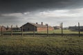 Barbed wire fence and buildings at Auschwitz II - Birkenau, former German Nazi Concentration and Extermination Camp - Poland Royalty Free Stock Photo