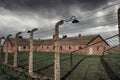 Barbed wire fence and buildings at Auschwitz II - Birkenau, former German Nazi Concentration and Extermination Camp - Poland Royalty Free Stock Photo